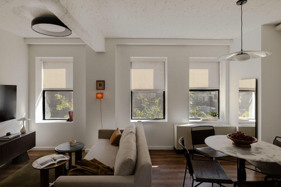 Bright and modern suite at Mint House with neutral decor, a cozy living area and large windows letting in natural light.