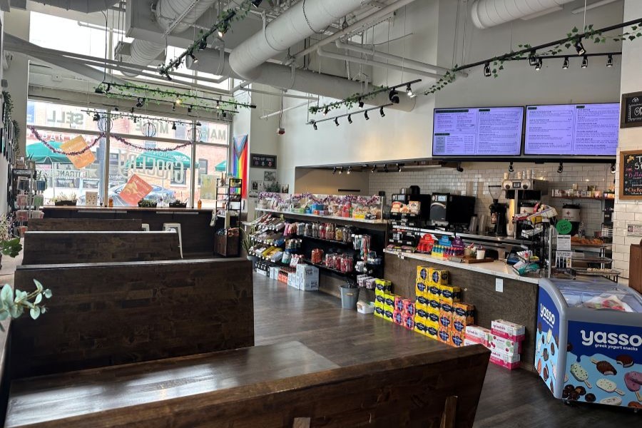 This image shows the interior of Union Kitchen, a modern DC-based food market and café featuring local products, a service counter, and spacious seating.