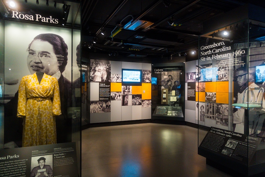 Display of Rosa Parks’ yellow dress and civil rights history panels at the National Museum of African American History and Culture.