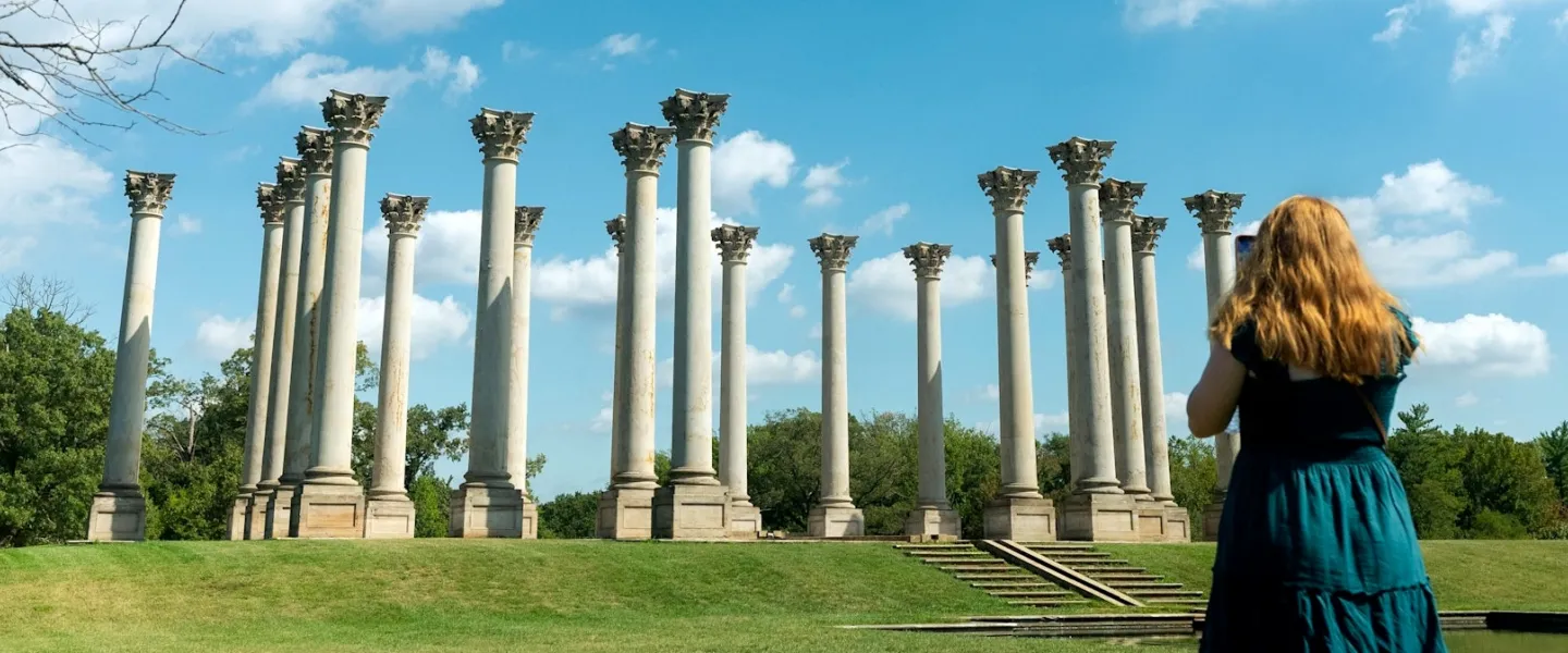 One person takes the photo of another with the Capitol Columns at the U.S. National Arboretum.